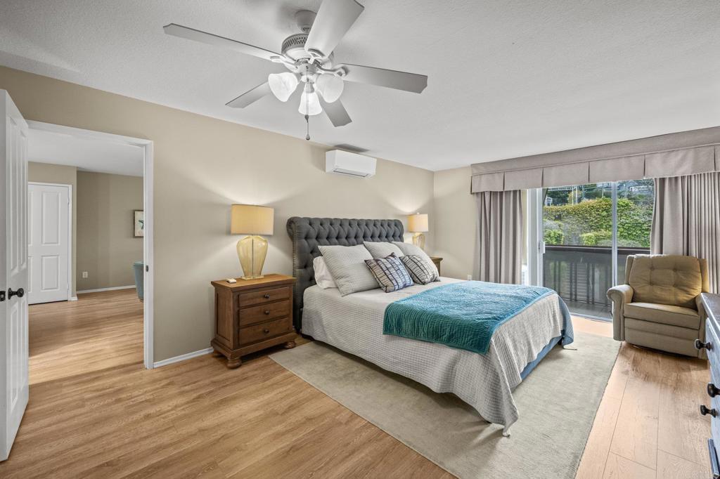 Bedroom with hillside greenery view and ductless mini-split.
