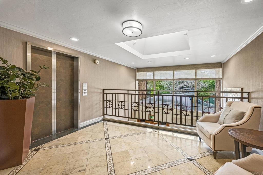 Building lobby with marble floors and skylight.